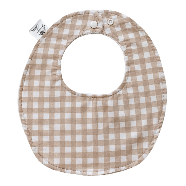 Sand gingham baby bib by Snuggly Jacks with an adjustable snap-button fastener, crafted for comfort and practicality, ideal for babies up to one year old.