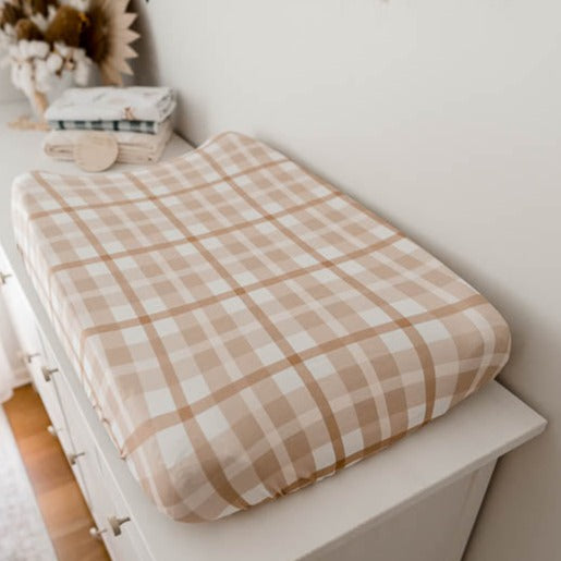 Earthy Plaid Bassinet Sheet / Change pad Cover set on top of a white pine chest of draws