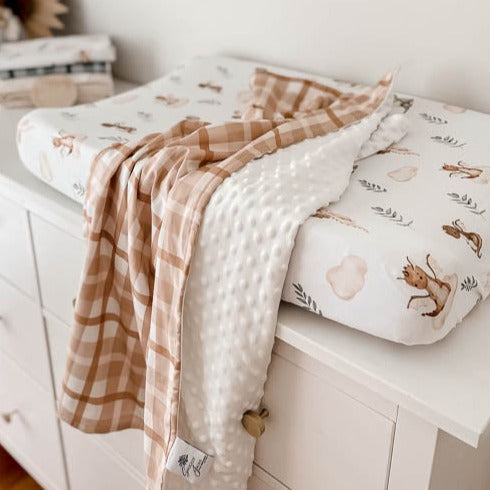 Dimple dot minky draped over a change mat table 