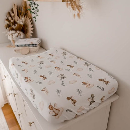 Change pad cover with dragons, leaves and clouds. The print is found in earthy browns, cinnamons and greens, great for any mother's modern nursery design.