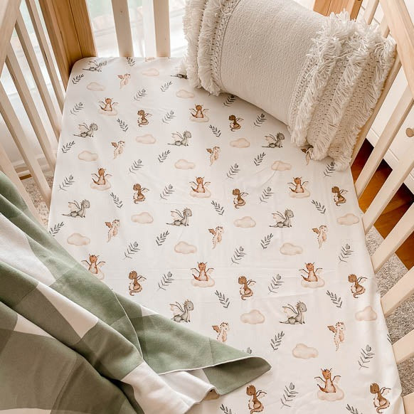 Cute fitted crib sheet from Snuggly Jacks Canada set in a pine crib.