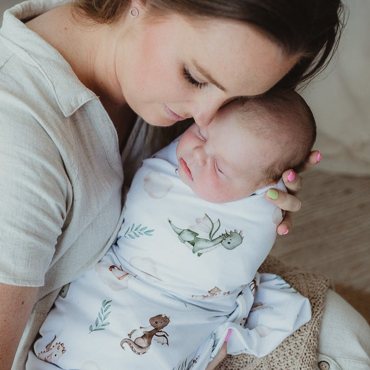 Mum and Bub sharing a sweet moment while the baby is swaddled in a jersey stretch wrap.