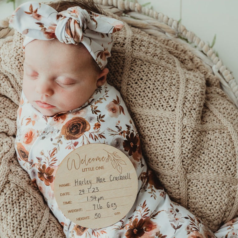 Baby all snug on a knitted cotton blanket with a snuggly jacks canada announcement disc.