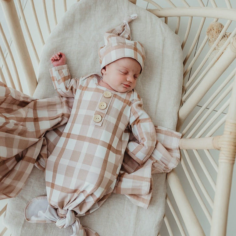 Happy sweet little baby sleeping in a cane bassinet with a smile