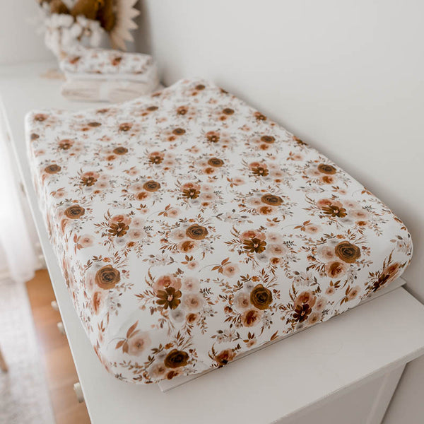 Change pad with a floral cover set on a change table. Multiuse Floral bassinet cover.