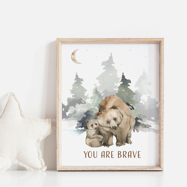 Wooden frame on a wall in a nursery with a picture of a brown bear and her cub in the woods